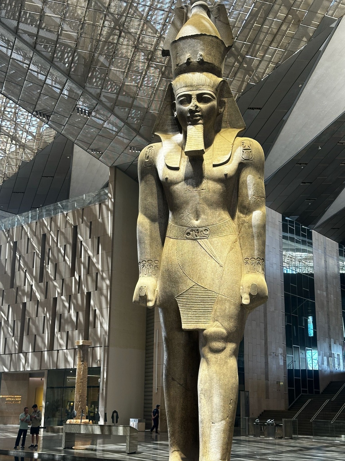 Grande statua egizia all'interno di un museo moderno