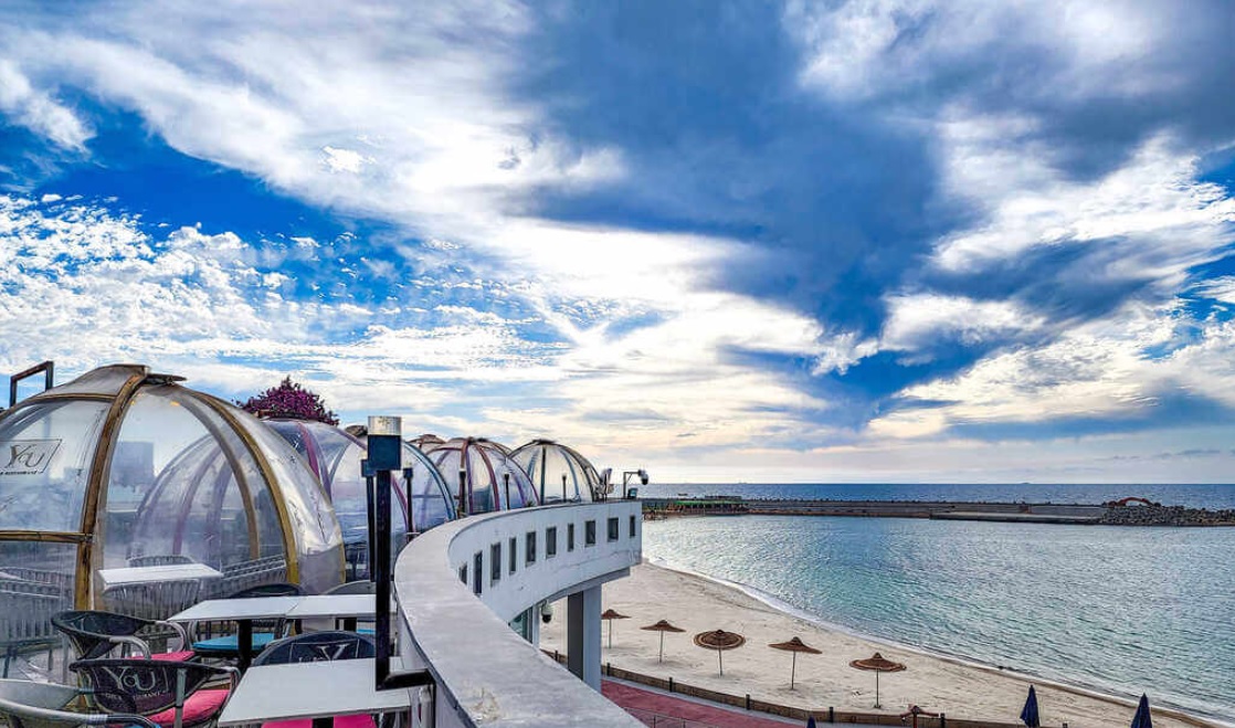 Modern cafe with transparent glass domes overlooking the Mediterranean Sea in Alexandria.