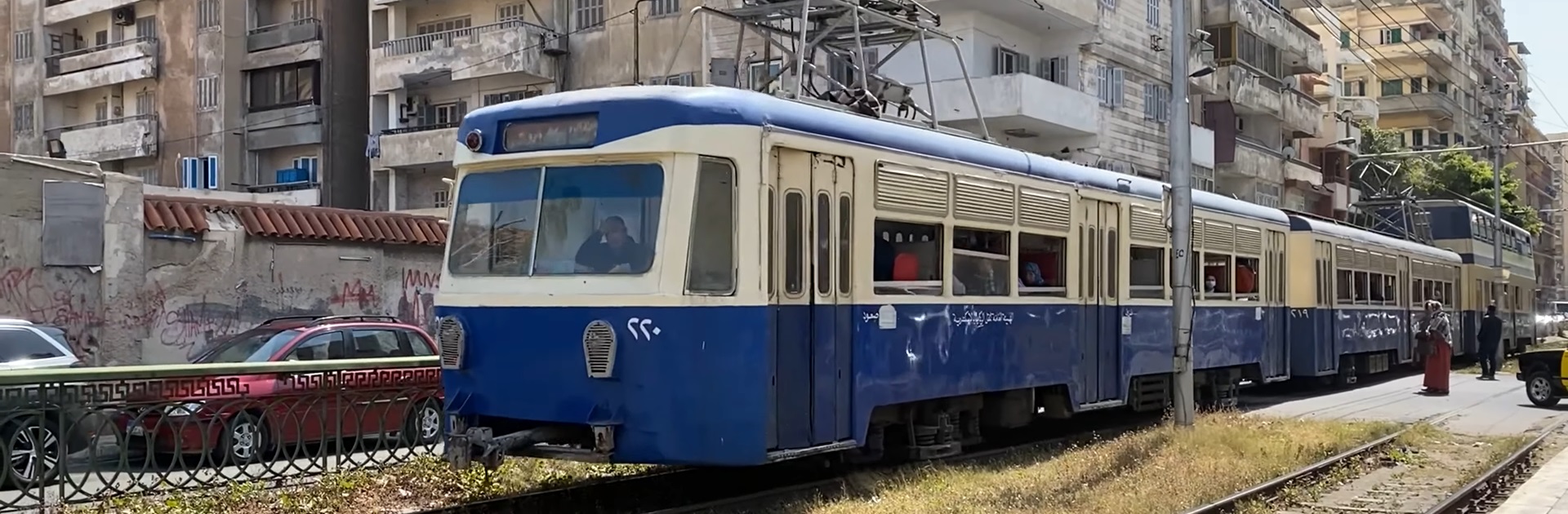 Vintage blue Raml tram on tracks for public transit in Alexandria, Egypt.