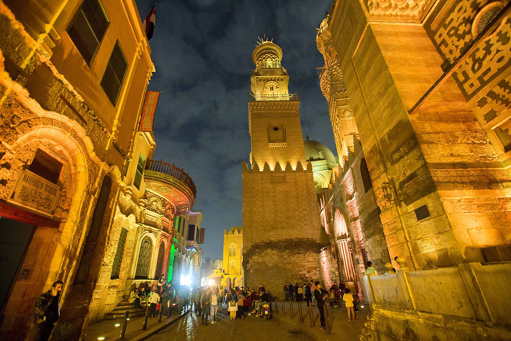 Rue historique avec un minaret illuminé la nuit