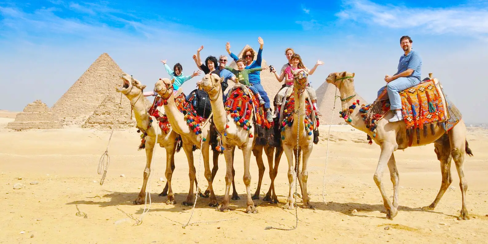 Grupo de turistas realizando un paseo en camello en Guiza.