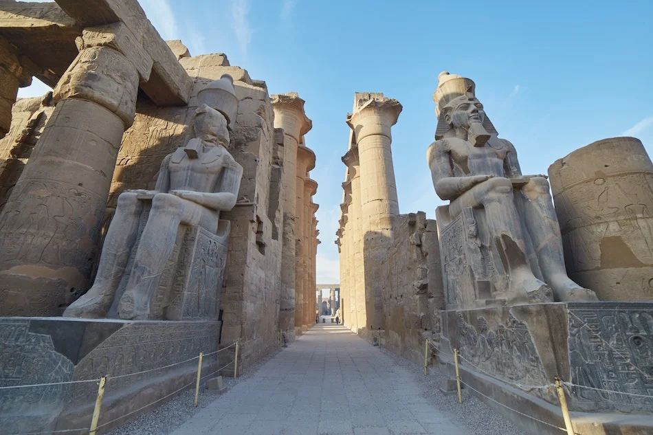 Monumentaler Eingang des Luxor-Tempels mit sitzenden Statuen am Nilufer