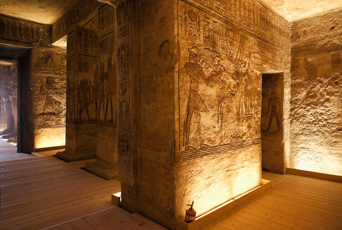 Stone corridor inside Abu Simbel Temple with ancient carvings.