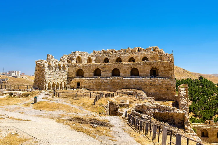 Visitors exploring the massive walls and historic halls of Karak Castle in Jordan