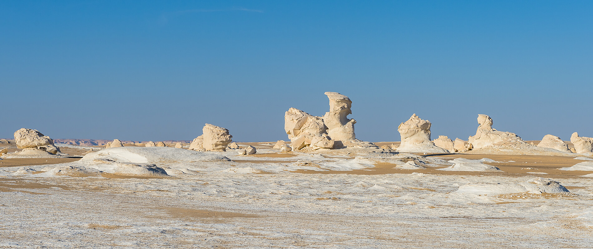 natural white chalk rock formations across the White Desert National Park in Egypt