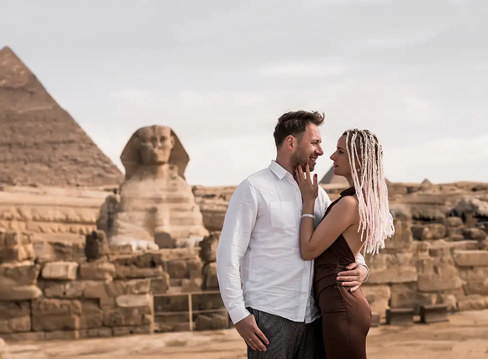 Couple posing for a photo in front of the Great Sphinx of Giza