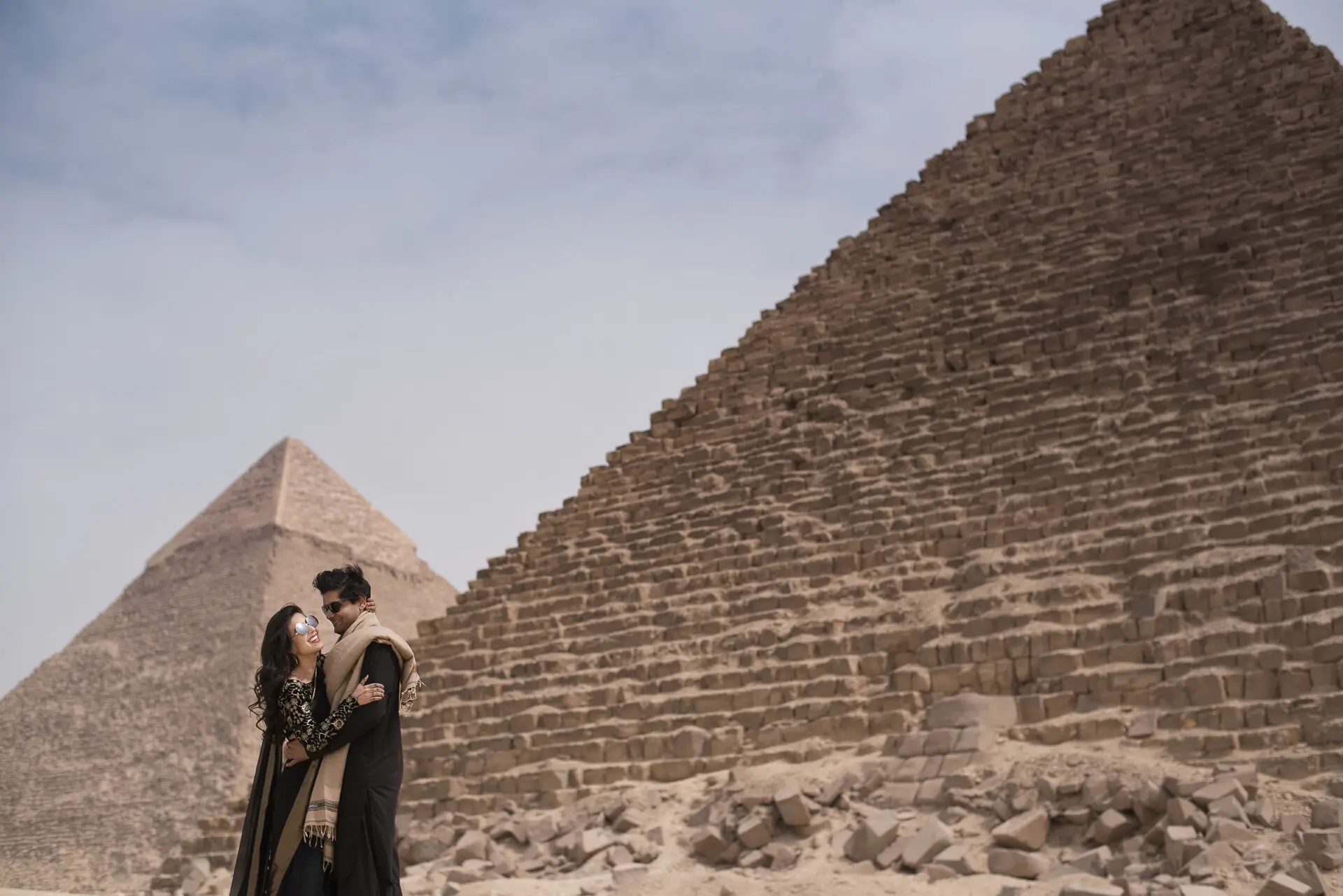 Couple against the backdrop of the iconic Giza Pyramids in Egypt