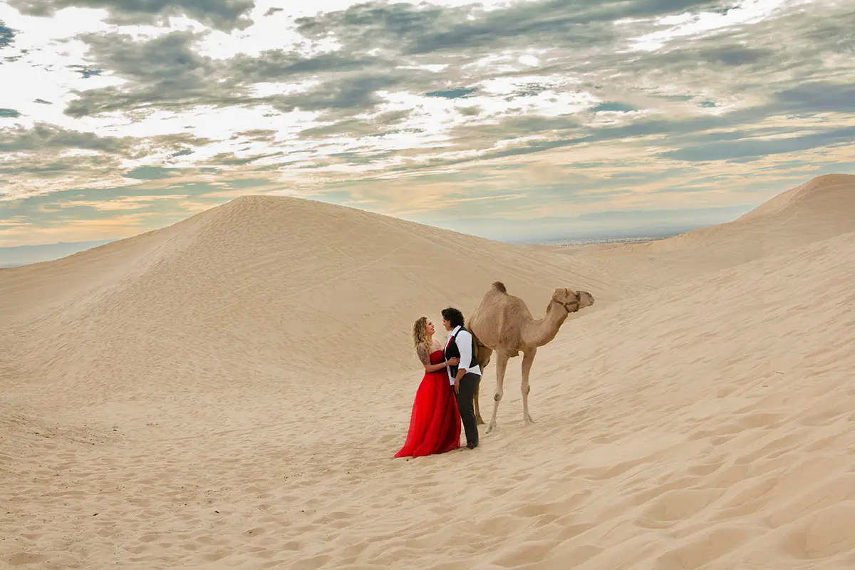 couple in egypt desert with camel during romantic safari tour
