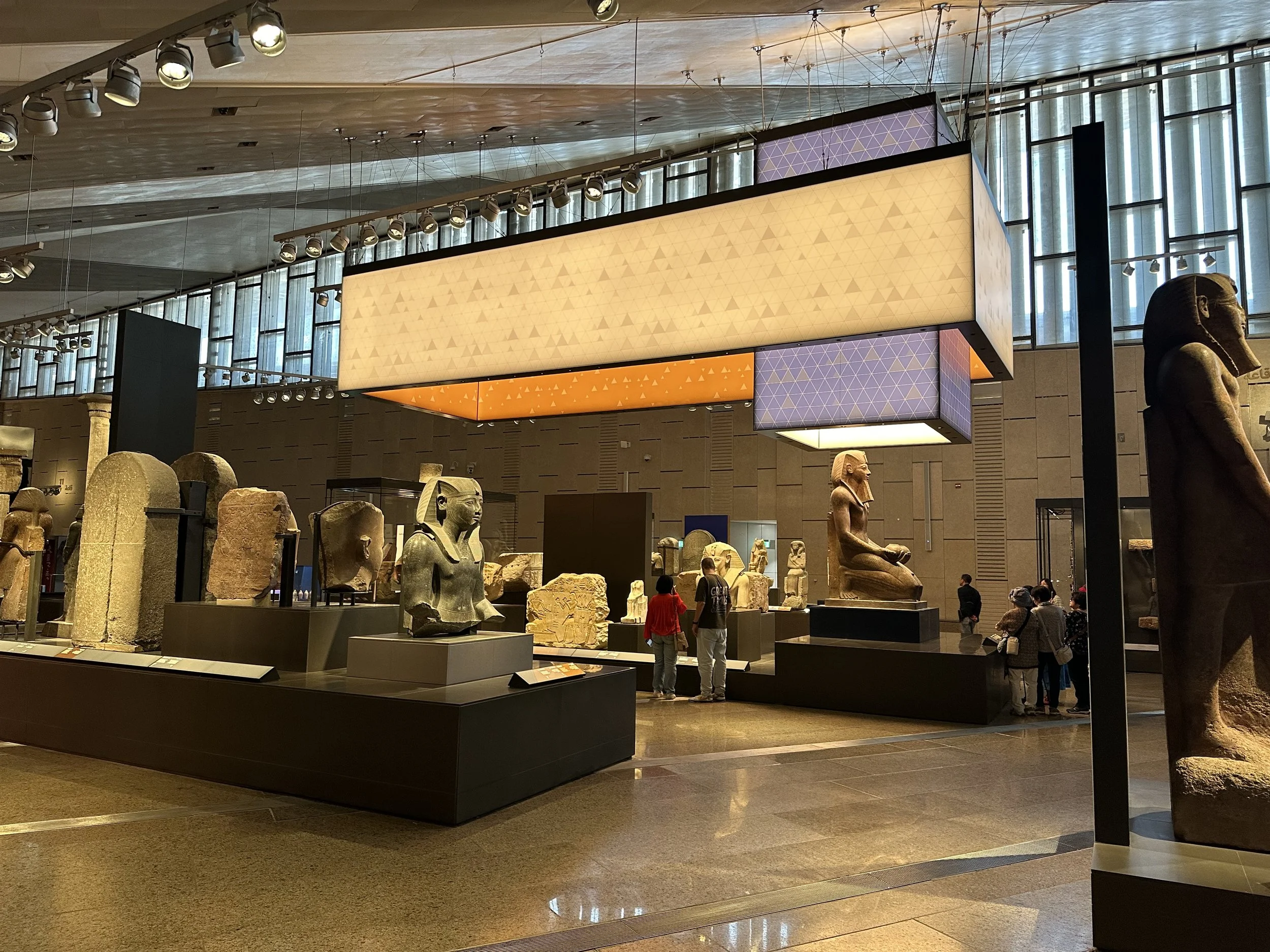 Ancient Egyptian statues displayed inside the Grand Egyptian Museum galleries